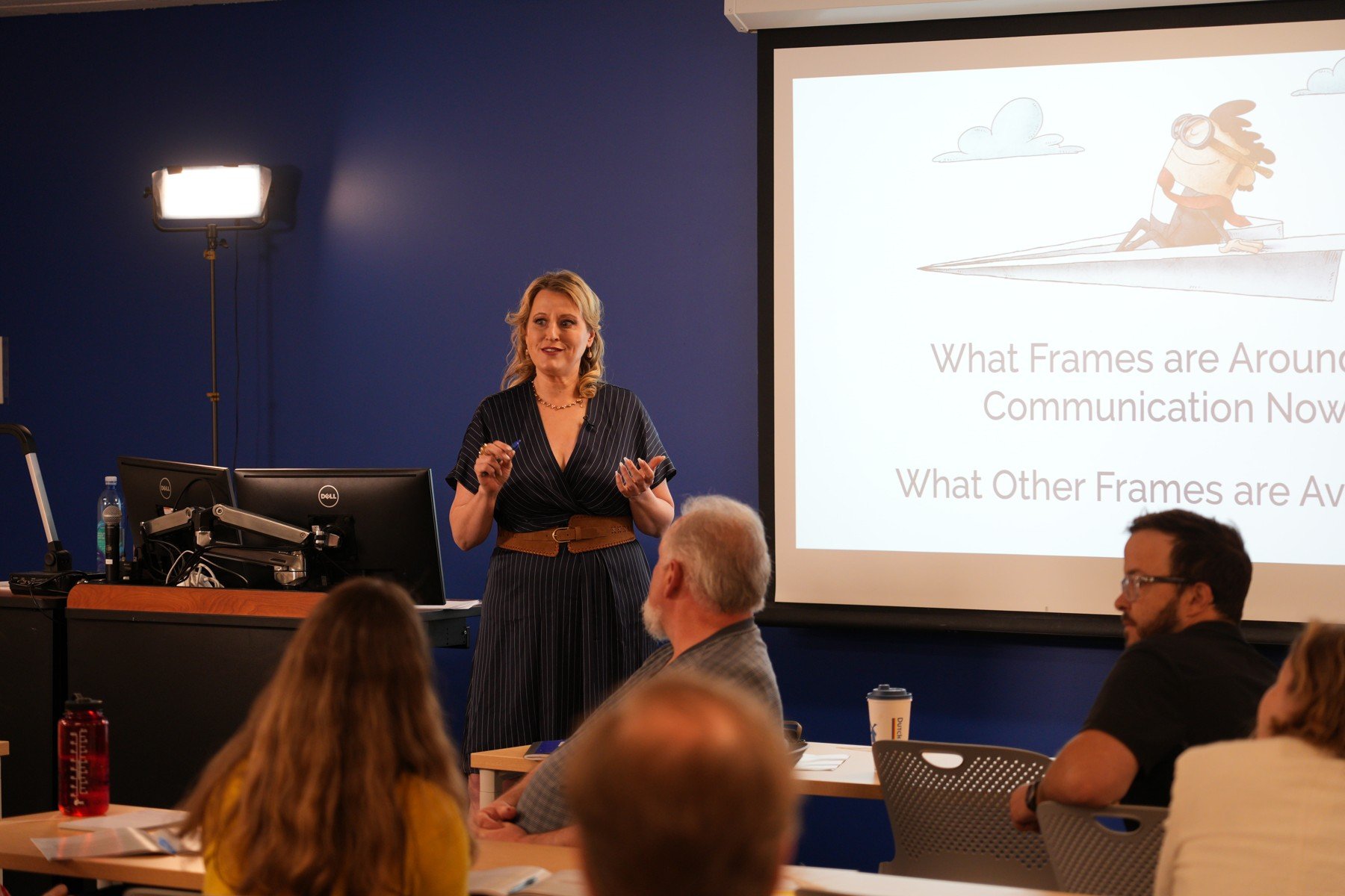 Elizabeth Edwards leading a communication workshop with participants seated in the foreground